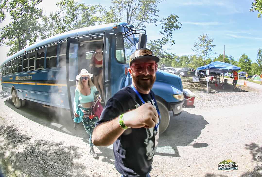 festival guest at ace adventure resort getting off the shuttle bus